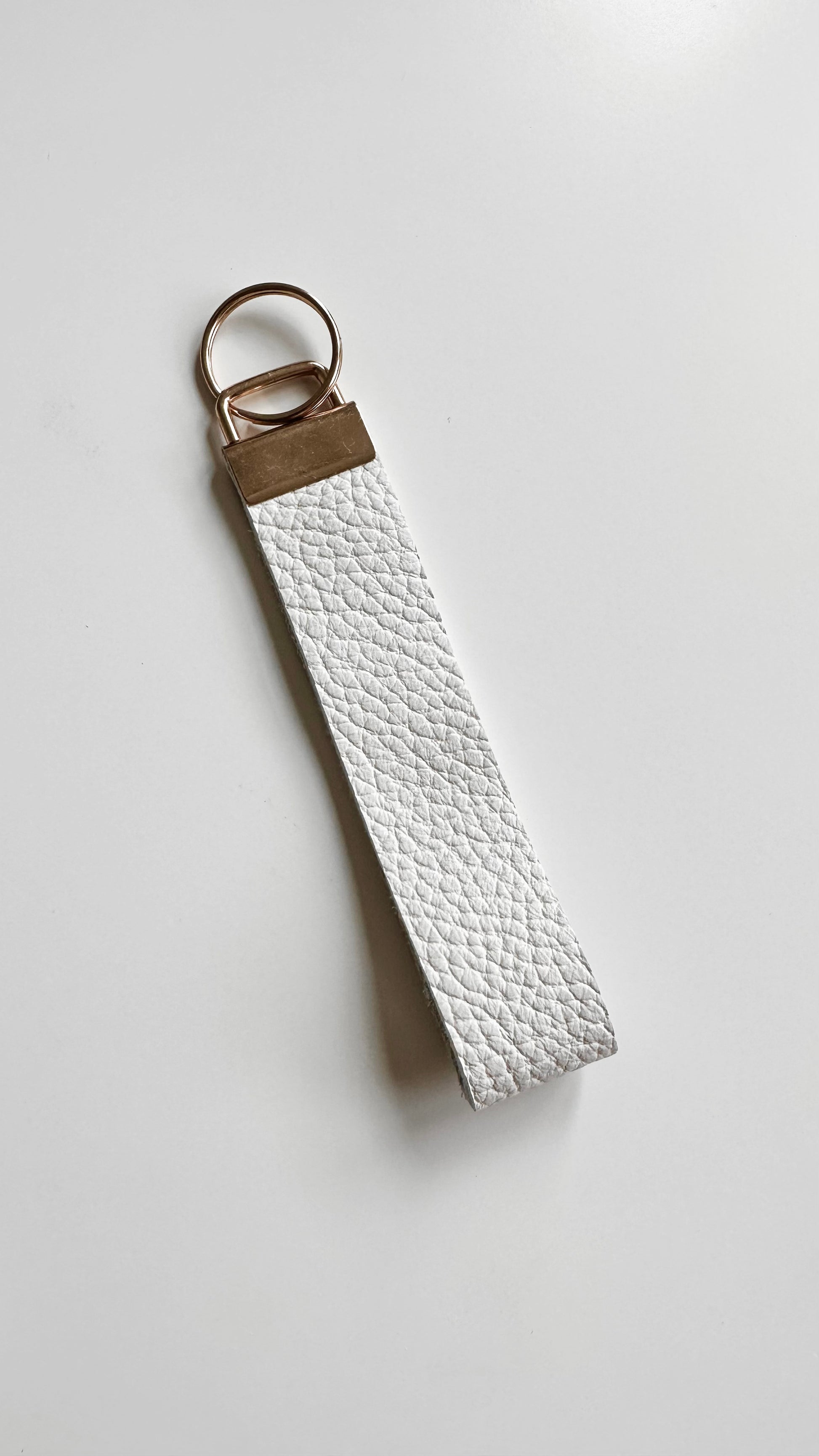 White genuine leather wristlet keychain.
